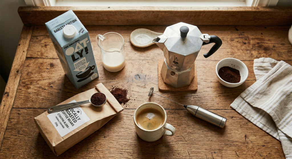 Making a flat white at home using a Moka pot and a handheld milk frother.